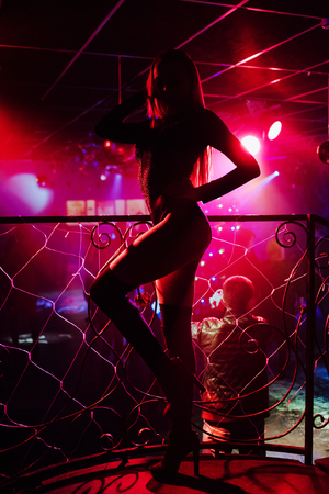 121588125-silhouette-of-a-girl-dancer-go-go-dancing-posing-in-a-nightclub